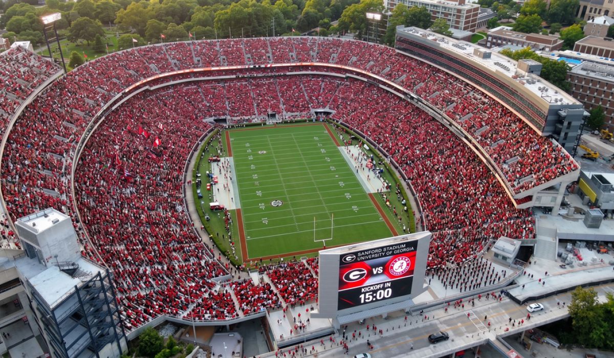 Magnolia A packed football stadium with fans in red, a green field, and a scoreboard showing Georgia vs. Charleston Southern.